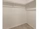 Bright and airy walk-in closet with wood-look tile flooring and ample storage at 9106 N 68Th Ln, Peoria, AZ 85345