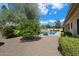 The backyard features a sparkling pool, mature trees, and lush landscaping at 10152 E Aster Dr, Scottsdale, AZ 85260