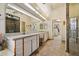 This bathroom offers dual sinks, a walk-in closet, and a glass shower at 10152 E Aster Dr, Scottsdale, AZ 85260
