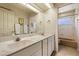 Bright bathroom with a double sink vanity and separate toilet room at 10152 E Aster Dr, Scottsdale, AZ 85260