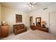 Cozy bedroom with a ceiling fan and comfortable seating area at 10152 E Aster Dr, Scottsdale, AZ 85260
