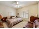 Bedroom has plantation shutters, ceiling fan, and wood furniture at 10152 E Aster Dr, Scottsdale, AZ 85260