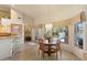 Dining area featuring a round wooden table set with seating for four and a view of the pool at 10152 E Aster Dr, Scottsdale, AZ 85260