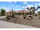 Charming home featuring desert landscaping, mature cacti, and a three-car garage at 10152 E Aster Dr, Scottsdale, AZ 85260