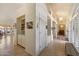Hallway featuring built-in shelves and arched entryways illuminated by a chandelier at 10152 E Aster Dr, Scottsdale, AZ 85260