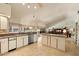 Open kitchen featuring granite countertops, stainless steel appliances, and center island overlooking living area at 10152 E Aster Dr, Scottsdale, AZ 85260