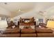 Comfortable living area with plush sofas, entertainment center, high ceilings, and natural light at 10152 E Aster Dr, Scottsdale, AZ 85260