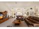 Spacious living room with high ceilings, ceiling fans, and comfortable leather furniture at 10152 E Aster Dr, Scottsdale, AZ 85260