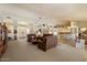 Expansive living room showcasing large sofas, neutral carpet and access to dining and kitchen areas at 10152 E Aster Dr, Scottsdale, AZ 85260