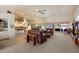 Open living area features a wet bar, large leather sofas, and views of the lake outside the windows at 10152 E Aster Dr, Scottsdale, AZ 85260