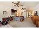 Spacious main bedroom showcasing a king bed, decorative art and sliding glass doors to the patio and pool at 10152 E Aster Dr, Scottsdale, AZ 85260