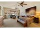 Spacious main bedroom featuring a seating area, bay window, and accent wall hanging at 10152 E Aster Dr, Scottsdale, AZ 85260
