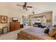 Spacious main bedroom featuring a sliding door to a patio, seating area, and king bed at 10152 E Aster Dr, Scottsdale, AZ 85260