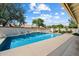 Beautiful pool with tiled water feature and a view of the well-maintained backyard at 10152 E Aster Dr, Scottsdale, AZ 85260