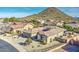 Aerial view of a home with a well-manicured yard in a quiet neighborhood with mountain views at 1078 W Desert Aster Rd, San Tan Valley, AZ 85143