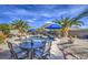 Beautifully landscaped backyard with a pool and outdoor seating area, perfect for entertaining guests at 1078 W Desert Aster Rd, San Tan Valley, AZ 85143