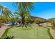 Beautiful backyard with a well manicured putting green and relaxing swimming pool at 1078 W Desert Aster Rd, San Tan Valley, AZ 85143