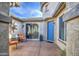 Charming courtyard with comfortable seating and a stylish blue front door, offering a welcoming outdoor space at 1078 W Desert Aster Rd, San Tan Valley, AZ 85143
