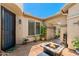 Cozy courtyard with a fire pit table and lush greenery, providing a tranquil outdoor retreat at 1078 W Desert Aster Rd, San Tan Valley, AZ 85143