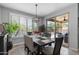 Dining area with modern light fixture offers great view of the sparkling pool and patio at 1078 W Desert Aster Rd, San Tan Valley, AZ 85143