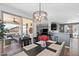 Dining room with modern chandelier looks out to the cozy outdoor living space and connects to the kitchen at 1078 W Desert Aster Rd, San Tan Valley, AZ 85143