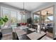 Dining area features a backyard view of the pool and a modern light fixture, offering a tranquil setting at 1078 W Desert Aster Rd, San Tan Valley, AZ 85143
