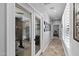 Bright hallway with tile flooring leading to an office featuring glass French doors at 1078 W Desert Aster Rd, San Tan Valley, AZ 85143