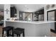 Modern kitchen boasts stainless appliances, white quartz countertops, dark cabinetry, and a breakfast bar with seating at 1078 W Desert Aster Rd, San Tan Valley, AZ 85143