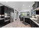 Modern kitchen with stainless steel appliances, sleek dark cabinetry, and ample counter space at 1078 W Desert Aster Rd, San Tan Valley, AZ 85143