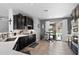 Open kitchen features stainless steel appliances, tile flooring, dark cabinets, and a casual dining area with outdoor access at 1078 W Desert Aster Rd, San Tan Valley, AZ 85143