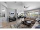 Spacious living room with comfortable seating flows into the dining area, creating an ideal space for relaxation at 1078 W Desert Aster Rd, San Tan Valley, AZ 85143