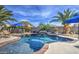 Gorgeous pool with a relaxing waterfall feature and patio area, perfect for outdoor living at 1078 W Desert Aster Rd, San Tan Valley, AZ 85143