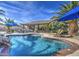 Inviting backyard pool surrounded by lush landscaping and lounge seating, perfect for outdoor relaxation at 1078 W Desert Aster Rd, San Tan Valley, AZ 85143
