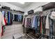 Organized walk-in closet with clothing racks, shelves, drawers, shoe storage and storage baskets at 1078 W Desert Aster Rd, San Tan Valley, AZ 85143