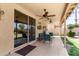 Covered patio boasts tile flooring, ceiling fans, and stylish furniture, perfect for outdoor enjoyment at 11518 W Dana Ln, Avondale, AZ 85392