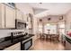 Sunlit kitchen with stainless steel appliances, light wood cabinets, and a breakfast nook for casual dining at 11518 W Dana Ln, Avondale, AZ 85392