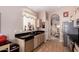 Kitchen featuring sleek countertops, stainless steel appliances, and an archway to the dining room at 11518 W Dana Ln, Avondale, AZ 85392