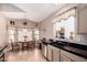 Well-lit kitchen with stainless steel appliances, breakfast nook, and stylish black countertops at 11518 W Dana Ln, Avondale, AZ 85392