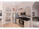Charming kitchen with stainless steel appliances, light wood cabinets, and access to dining room at 11518 W Dana Ln, Avondale, AZ 85392