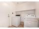 This laundry room features a washer and dryer, and a door to the exterior of the home at 11518 W Dana Ln, Avondale, AZ 85392