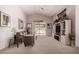 Cozy living room features neutral walls, carpet, an entertainment center and access to the backyard at 11518 W Dana Ln, Avondale, AZ 85392