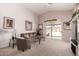 Living room with a sliding glass door to backyard, a ceiling fan, and neutral decor at 11518 W Dana Ln, Avondale, AZ 85392