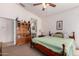 Spacious bedroom with a ceiling fan and a large bookshelf for ample storage at 11518 W Dana Ln, Avondale, AZ 85392