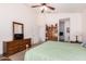 Large bedroom boasts a ceiling fan and views into an ensuite bathroom at 11518 W Dana Ln, Avondale, AZ 85392
