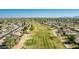 Expansive aerial view of homes lining a lush green golf course with distant mountain views at 12021 S Tomi Dr, Phoenix, AZ 85044