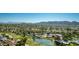 Stunning aerial view of the community, showcasing lush landscapes, lakes, and the distant mountains at 12021 S Tomi Dr, Phoenix, AZ 85044