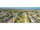 Scenic aerial perspective of the neighborhood, featuring a tranquil lake and a verdant golf course at 12021 S Tomi Dr, Phoenix, AZ 85044