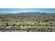 Panoramic aerial view of a golf community, showing homes, lush green fairways, and mountain views at 12021 S Tomi Dr, Phoenix, AZ 85044