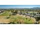 Aerial view of a golf course community with desert landscaping and mountain views in the background at 12021 S Tomi Dr, Phoenix, AZ 85044
