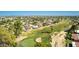 Aerial view of a golf course community with mature trees and a vibrant green fairway at 12021 S Tomi Dr, Phoenix, AZ 85044